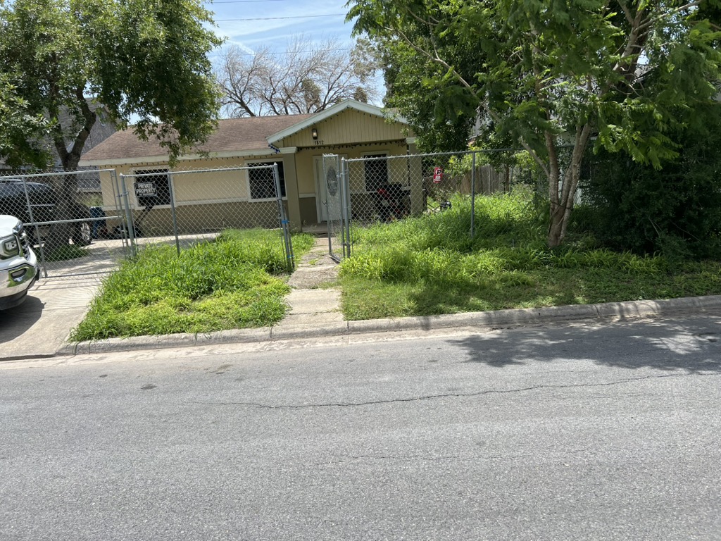 Severely neglected lawn requiring fertilization and major cleanup in Georgetown, TX. (Before Image)