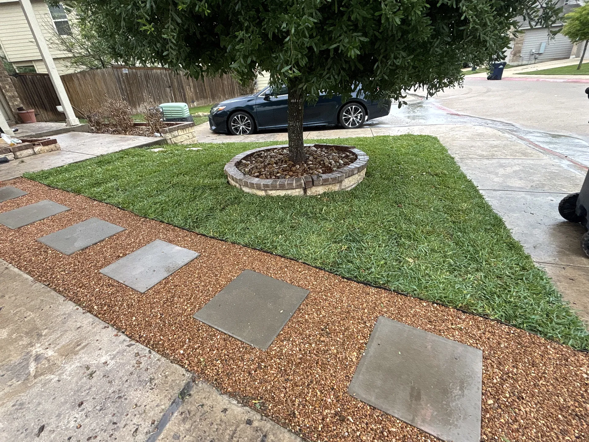 Completed landscape and lawn care project on a residential street.