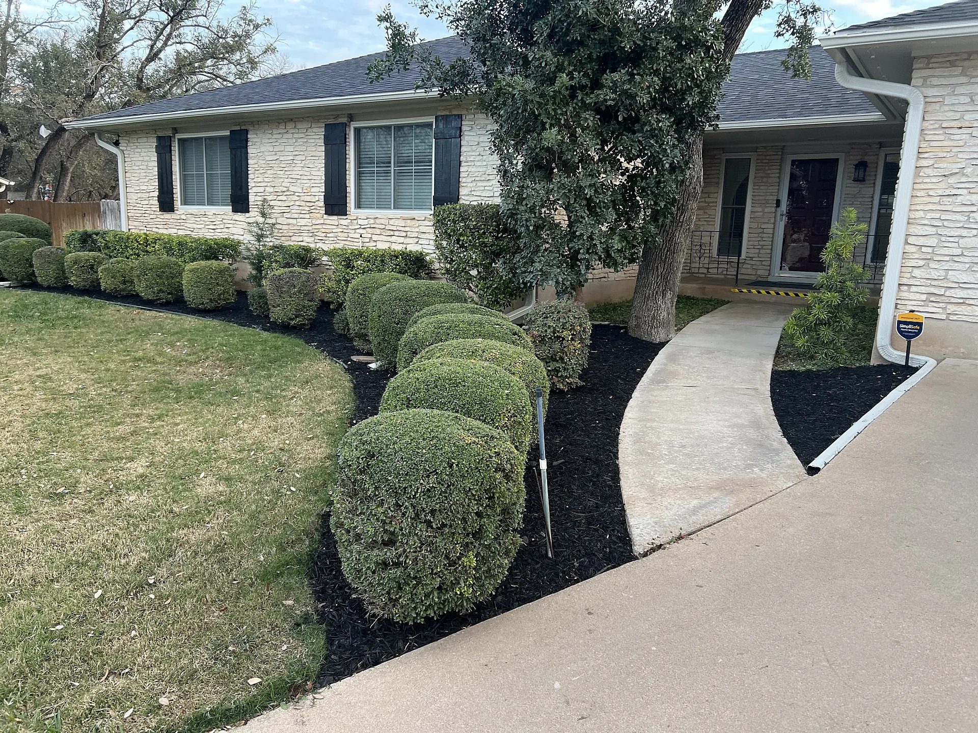 Application process showing even distribution of mulch around shrubs.